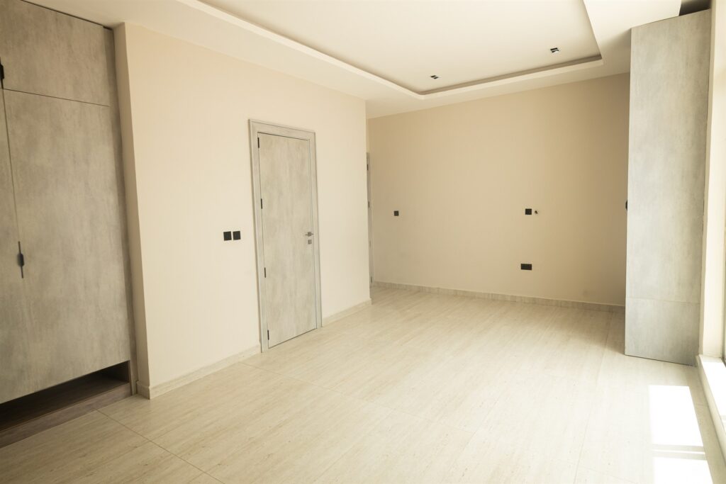 Brum Height 6: Bedroom with wood-tone wardrobes and tiled flooring